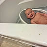 baby, bathtub, bath_seat, smiling, child, bathroom, water, skin, happy, infant, person, head, face, naked, young_child, home, indoor, clean, seat, relax