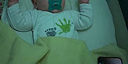 Owen a rejoint le concours — aidez-le/la à gagner de superbes lots ! baby, sleeping, pacifier, blanket, crib, infant, child, handprint, footprint, smartphone, device, indoors, bed, peaceful, resting, clothing, person, raised_hands, soft_lighting, quiet