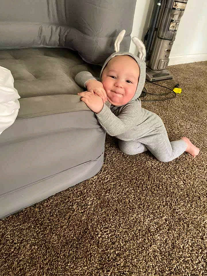 Stormy is registered to the contest to win money with this photo: baby, baby_toddler_clothing, child, comfort, couch, eye, face, flash_photography, floor, flooring, grass, hairstyle, happy, hardwood, head, human_body, person, road_surface, smile, toddler