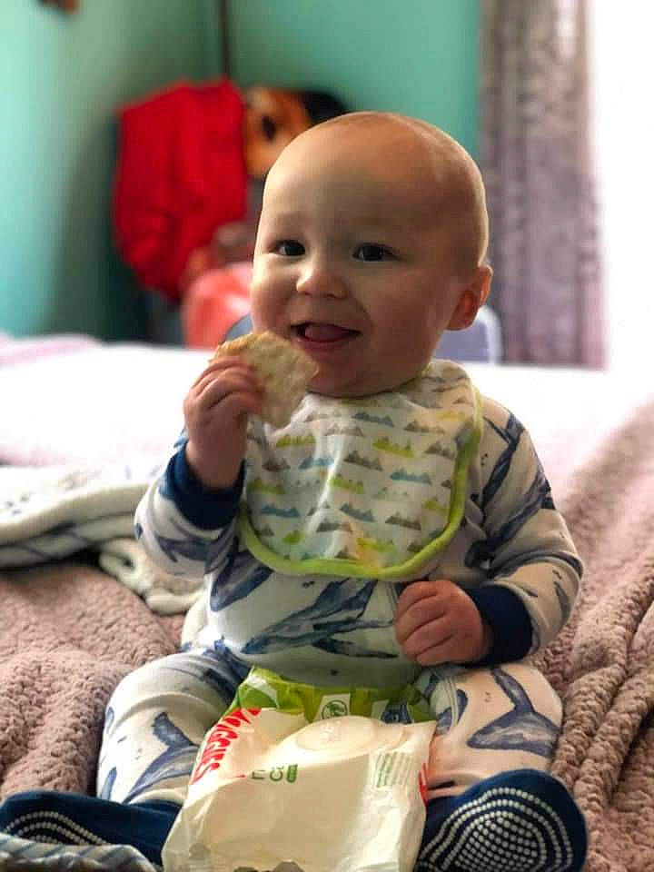 Stormy is registered to the contest to win money with this photo: baby, baby_toddler_clothing, cheek, child, comfort, flooring, fun, happy, iris, linens, pattern, person, room, sitting, skin, sleeve, smile, t_shirt, thumb, toddler