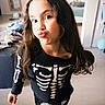 Chloe participe au concours pour gagner de l'argent avec cette photo : child, costume, skeleton, face, long_hair, indoor, playful, duck_face, clothing, mirror, balloon, floor, bedroom, casual, pose, young, person, smile, hair, fun