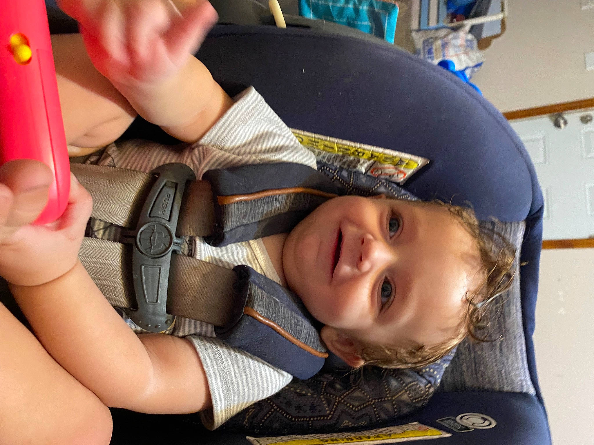 Jaxon is registered to the contest to win money with this photo: auto_part, baby_products, car_seat, child, eyelash, fashion_accessory, finger, fun, gesture, hand, happy, joy, mouth, nail, person, personal_protective_equipment, seat_belt, smile, strap, thumb