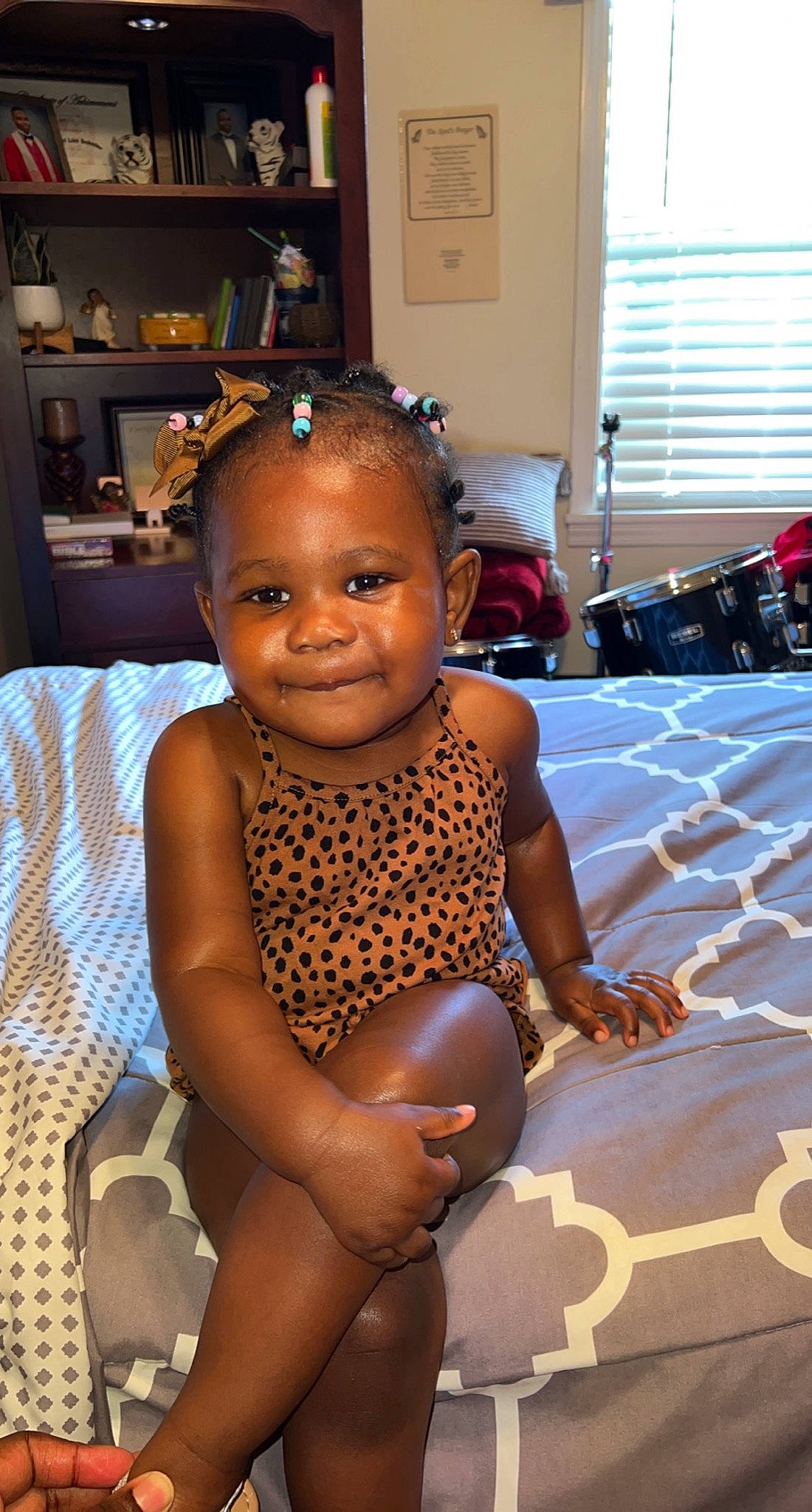 Raelynn is registered to the contest to win money with this photo: baby, chair, chest, child, event, eye, flash_photography, floor, flooring, fun, happy, human_leg, joy, leisure, person, shelf, sitting, smile, thigh, toddler