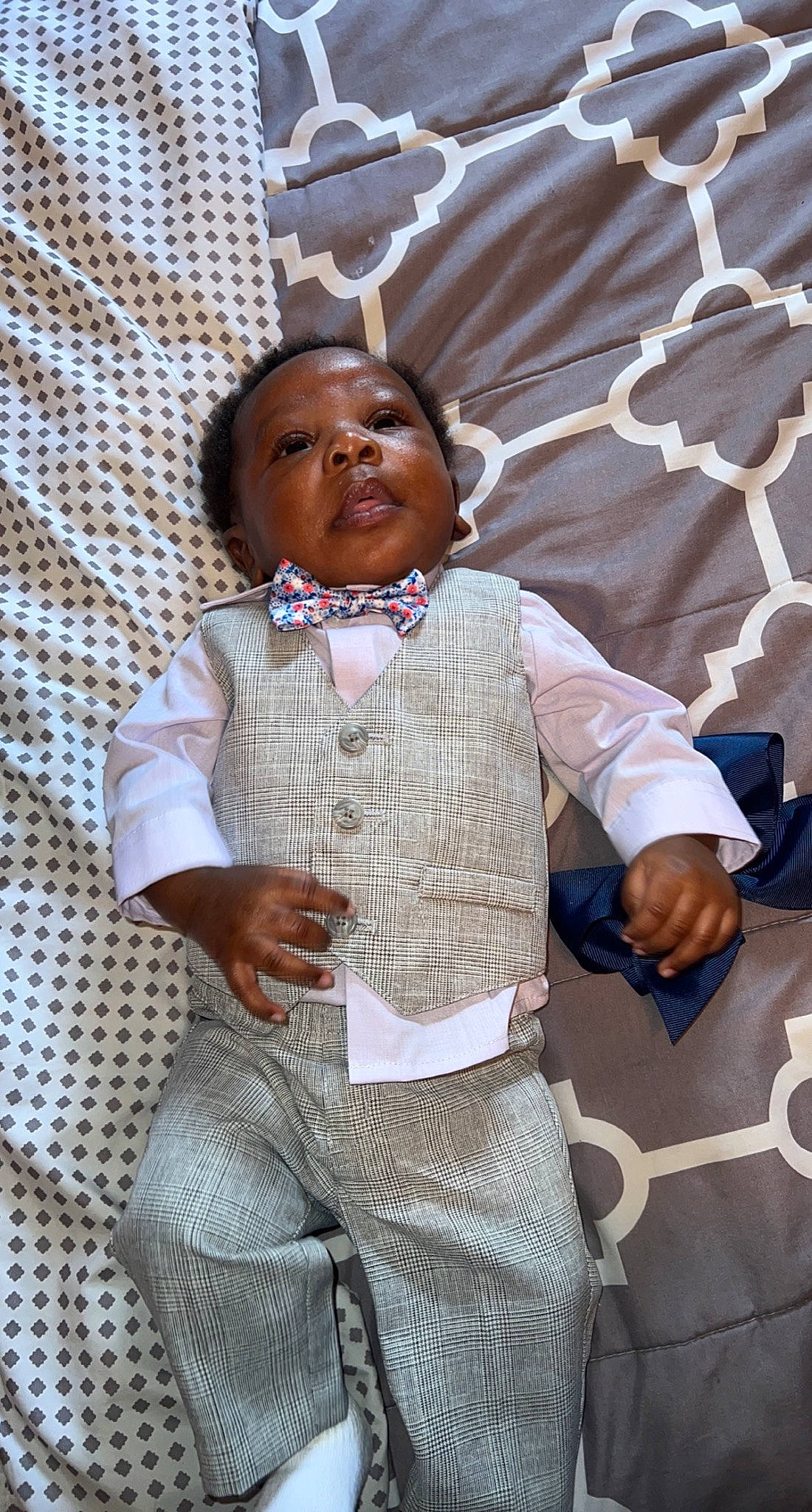 Haden is registered to the contest to win money with this photo: baby_toddler_clothing, child, door, dress, event, fashion_design, formal_wear, gesture, happy, headgear, human_body, jewellery, outerwear, pattern, person, room, skin, sleeve, tie, toddler