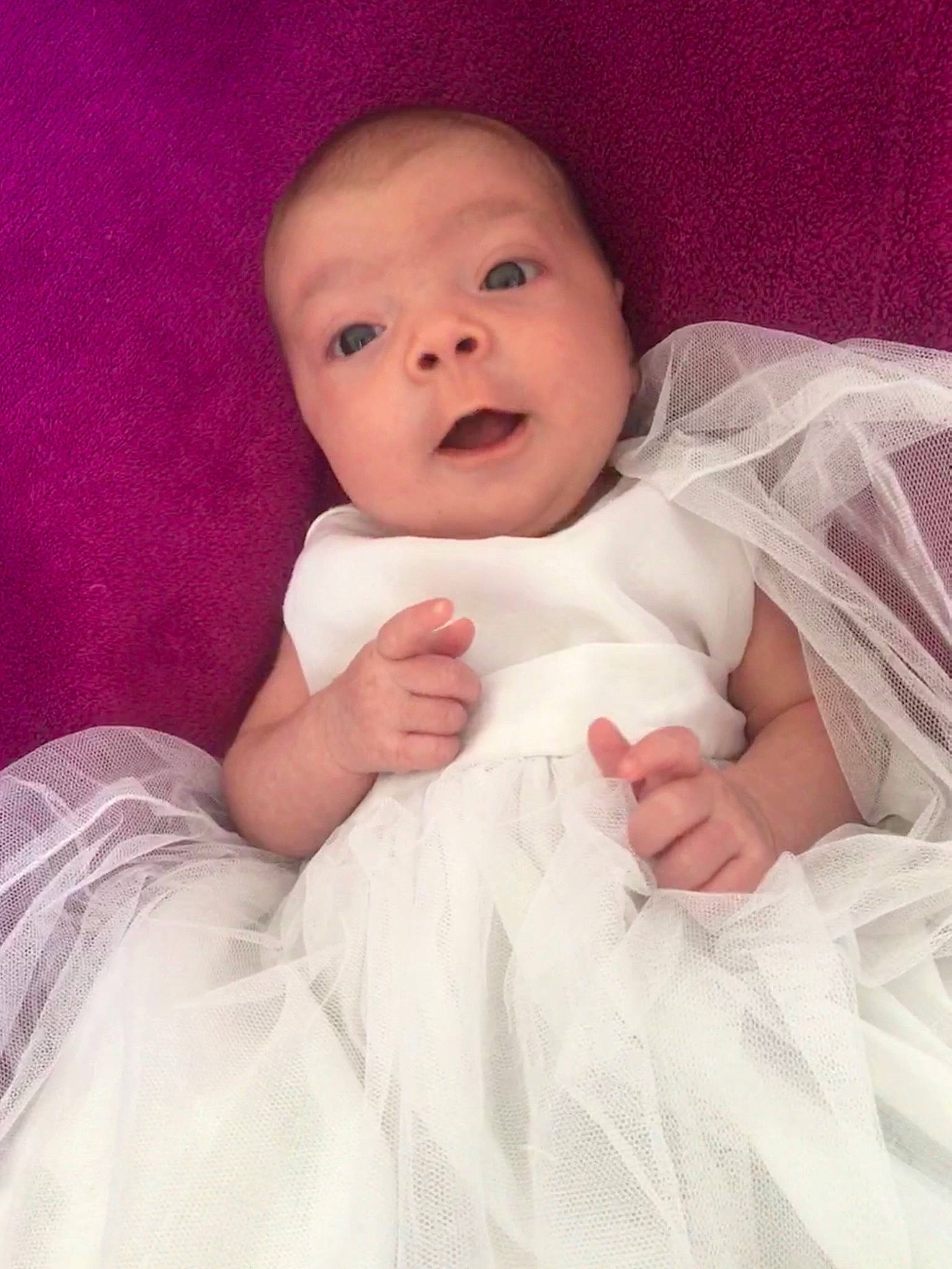 Colyne participe au concours pour gagner de l'argent avec cette photo : arm, baby, baby_toddler_clothing, cheek, comfort, dress, eye, eyebrow, finger, flash_photography, gesture, hand, happy, iris, lip, neck, person, pink, skin, sleeve