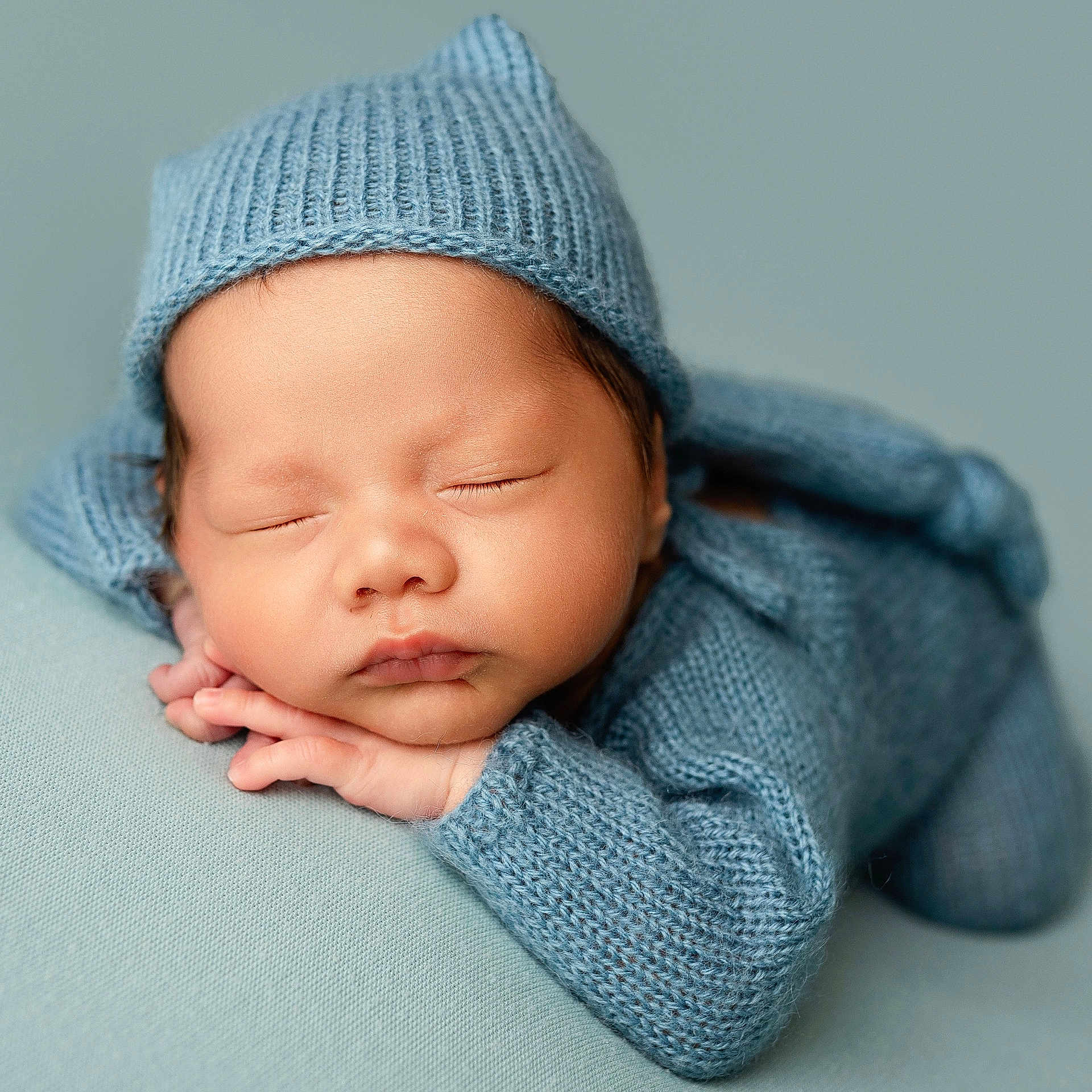 Freddie is registered to the contest to win money with this photo: baby, beanie, bonnet, cap, clothing, face, happy, hat, head, hood, hoodie, knitwear, newborn, person, photography, portrait, sleeping, smile, sweater, sweatshirt