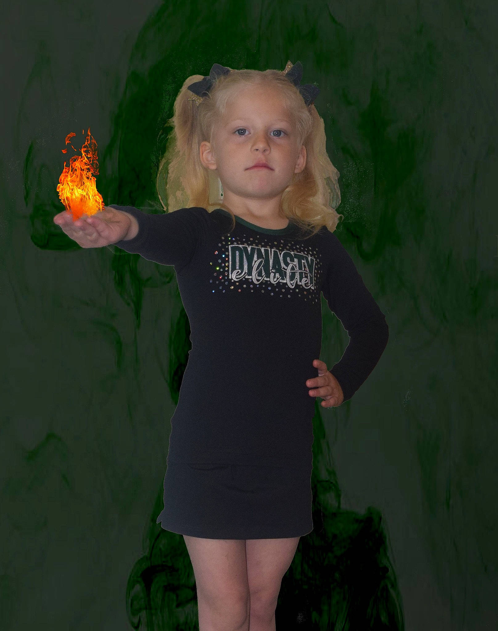 Anna is registered to the contest to win money with this photo: baby_toddler_clothing, blond, day_dress, face, finger, fun, gesture, hand, happy, human_leg, joint, knee, long_hair, one_piece_garment, pattern, person, sleeve, sportswear, t_shirt, thigh