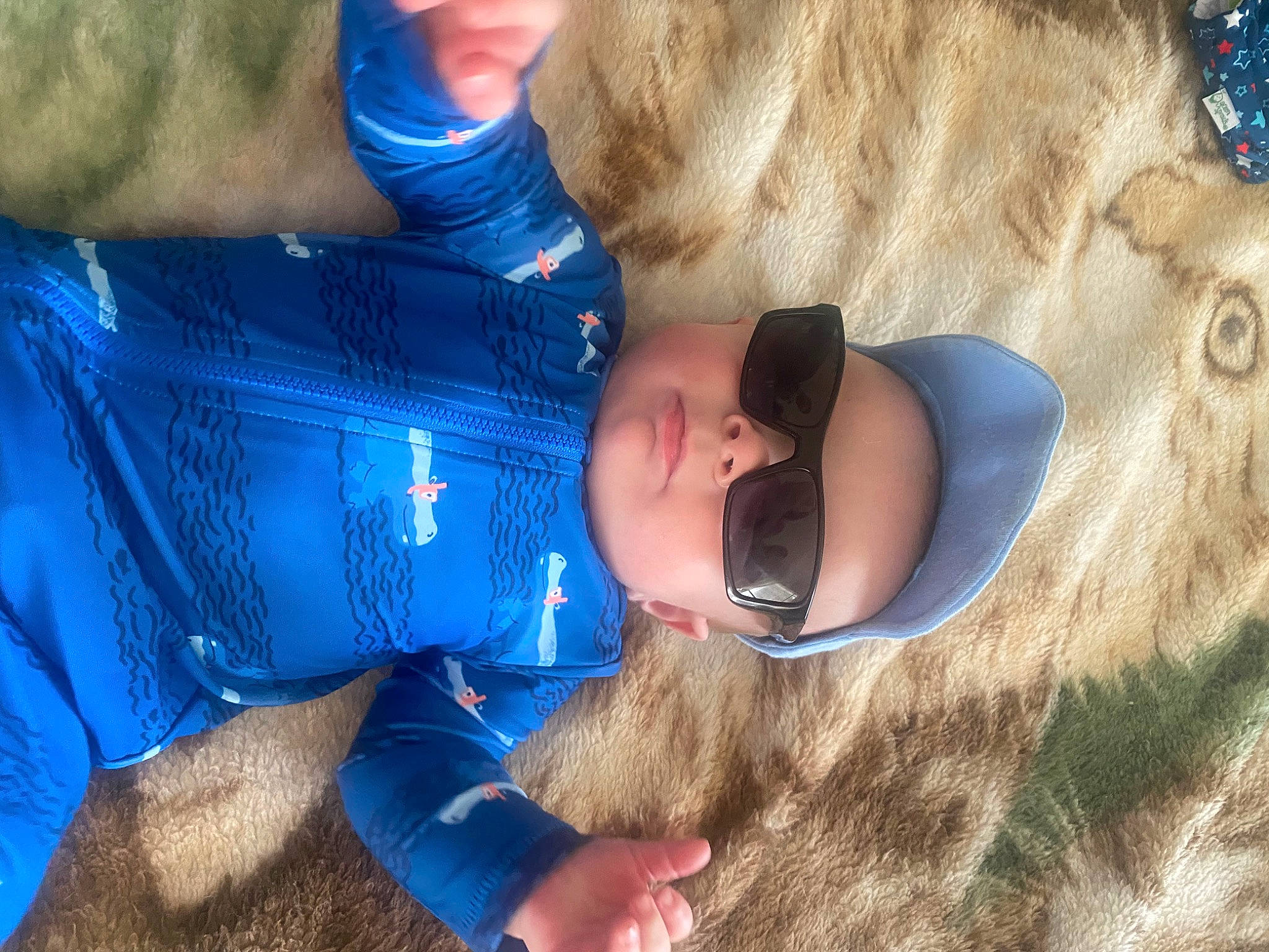 Jaxon joined the competition — help win amazing prizes! baby, blue, child, comfort, electric_blue, facial_expression, finger, fun, fur, grass, hand, happy, head, headwear, interaction, leisure, mouth, person, play, sitting