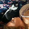 Bear is registered to the contest to win money with this photo: animal, bed, bedroom, black_and_white_cat, blanket, cat, cozy, cuddling, face, fur, green_eyes, human, indoors, lying_down, pet, photography, portrait, relaxed, sleeping_person, whiskers