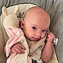 baby, blanket, child, clothing, comfort, cushion, cute, expression, face, hand, head, indoor, infant, newborn, person, plush_toy, resting, seat, skin, soft