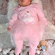 Ilinca a rejoint le concours — aidez-le/la à gagner de superbes lots ! baby, sleeping, pink_outfit, tutu, swan_design, blanket, cotton_bolls, teddy_bear, blue_heart, wooden_floor, infant, soft_toys, cozy, cute, portrait, child, clothing, resting, indoor, adorable