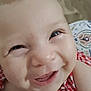baby, baby_clothes, cheeks, child, close_up, cute, expression, eyes, face, happy, head, indoors, infant, mouth, person, portrait, red_checkered_clothing, skin, smiling, young