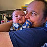 Hudson is registered to the contest to win money with this photo: affection, baby, child, closeup, clothing, comfort, couch, expression, face, family, father, hug, indoor, love, man, onesie, parent, pattern, portrait, skin