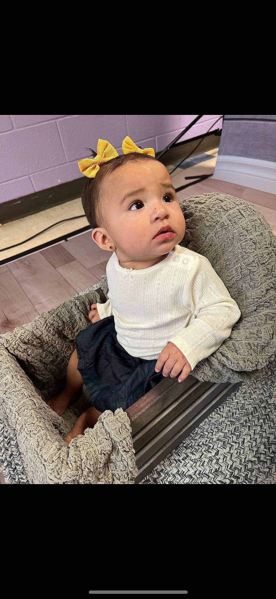 Daniella is registered to the contest to win money with this photo: baby, baby_products, baby_toddler_clothing, cap, cheek, child, comfort, costume_hat, fashion_accessory, flooring, fun, happy, hat, pattern, person, room, selfie, sitting, sleeve, t_shirt