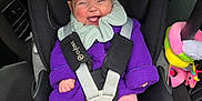 Isabelle is registered to the contest to win money with this photo: baby, car_seat, purple_sweater, pink_leggings, smiling, infant, child, toy, plush_toy, car_interior, seatbelt, safety, happy, cute, portrait, child_seat, infant_clothing, car, seat, baby_smile