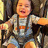 baby, stroller, denim_overalls, mickey_mouse, smiling, happy, child, sunlight, outdoor, clothing, seatbelt, baby_trend, infant, cute, portrait, person, seat, legs, arm, face
