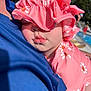 baby, child, sleeping, pink_hat, pink_clothing, daisy_pattern, close_up, outdoor, sunlight, pale_skin, person, portrait, resting, cute, summer, poolside, soft_light, headwear, face, peaceful