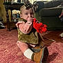 River joined the competition — help win amazing prizes! baby, child, indoor, carpet, toy, stuffed_animal, thumb_sucking, headband, fur_vest, boots, pink, leopard_print, living_room, sofa, table, curtains, cute, sitting, person, cozy