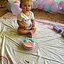 toddler, child, cake, birthday, balloons, plastic_sheet, rainbow, frosting, face_paint, indoors, brick_wall, floor, party, celebration, sitting, cup, colorful, messy, cute, young_child