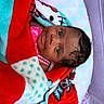 Yaleia joined the competition — help win amazing prizes! baby, child, blanket, colorful, red, turquoise, polka_dot, face, expression, cushion, crib, mesh, pattern, pink_clothing, portrait, indoor, soft_texture, infant, wrapped, cute