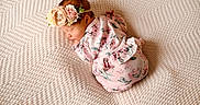 Yasmine joined the competition — help win amazing prizes! adorable, baby, baby_clothes, blanket, child, closeup, cozy, cute, flower_headband, infant, newborn, peaceful, pink_outfit, portrait, resting, serene, sleep, sleeping, soft_lighting, texture