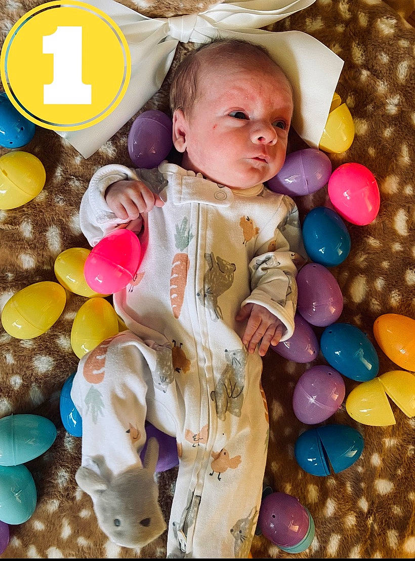 Camden is registered to the contest to win money with this photo: baby, baby_toddler_clothing, balloon, beauty, child, event, facial_expression, fun, happy, human, pattern, people, person, photograph, pink, product, snapshot, textile, toddler, white