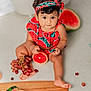 baby, child, fruit, grapes, watermelon, grapefruit, orange, milestone_marker, headband, clothing, sitting, cute, indoors, fresh, healthy, playful, photography, portrait, food, colorful