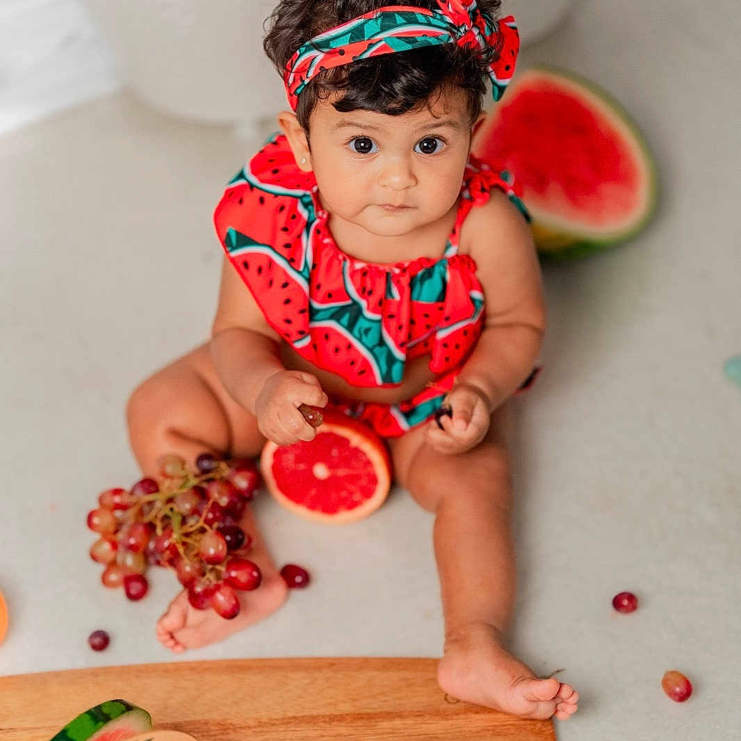Millir is registered to the contest to win money with this photo: baby, child, clothing, colorful, cute, food, fresh, fruit, grapefruit, grapes, headband, healthy, indoors, milestone_marker, orange, photography, playful, portrait, sitting, watermelon