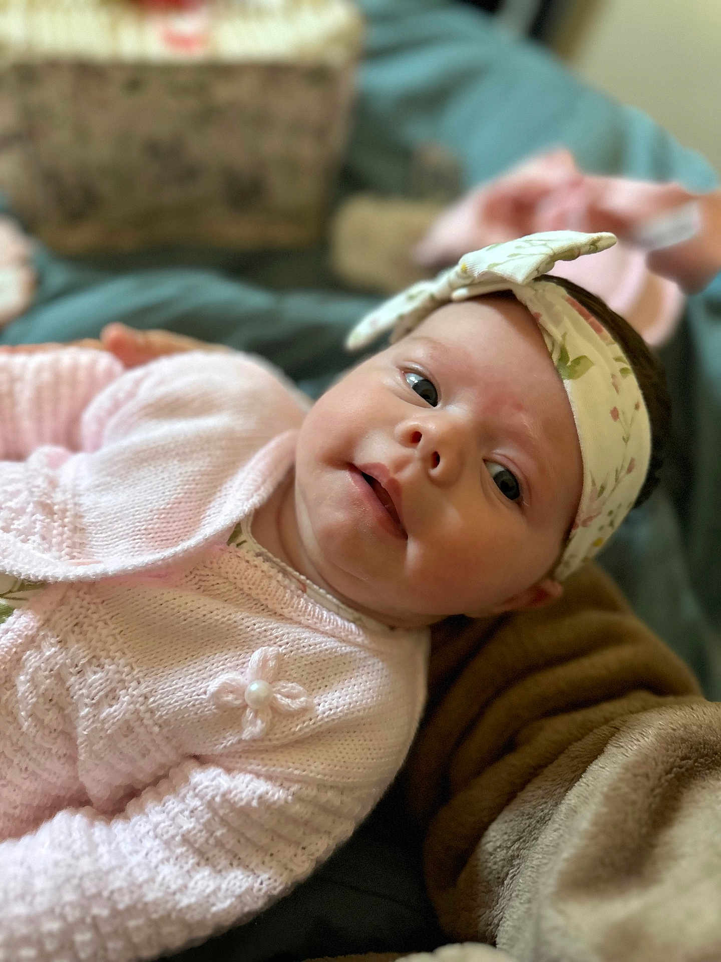 Freya-Joy is registered to the contest to win money with this photo: baby, infant, headband, pink_sweater, knitwear, face, portrait, child, cute, lying_down, soft_lighting, cozy, blanket, fabric, indoor, closeup, expression, skin, person, young