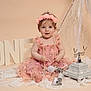 baby, girl, pink_dress, flower_headband, pearls, old_fashioned_telephone, lace, birthday, one_year, studio, portrait, smiling, sitting, decor, pastel, cute, child, celebration, accessories, soft_lighting