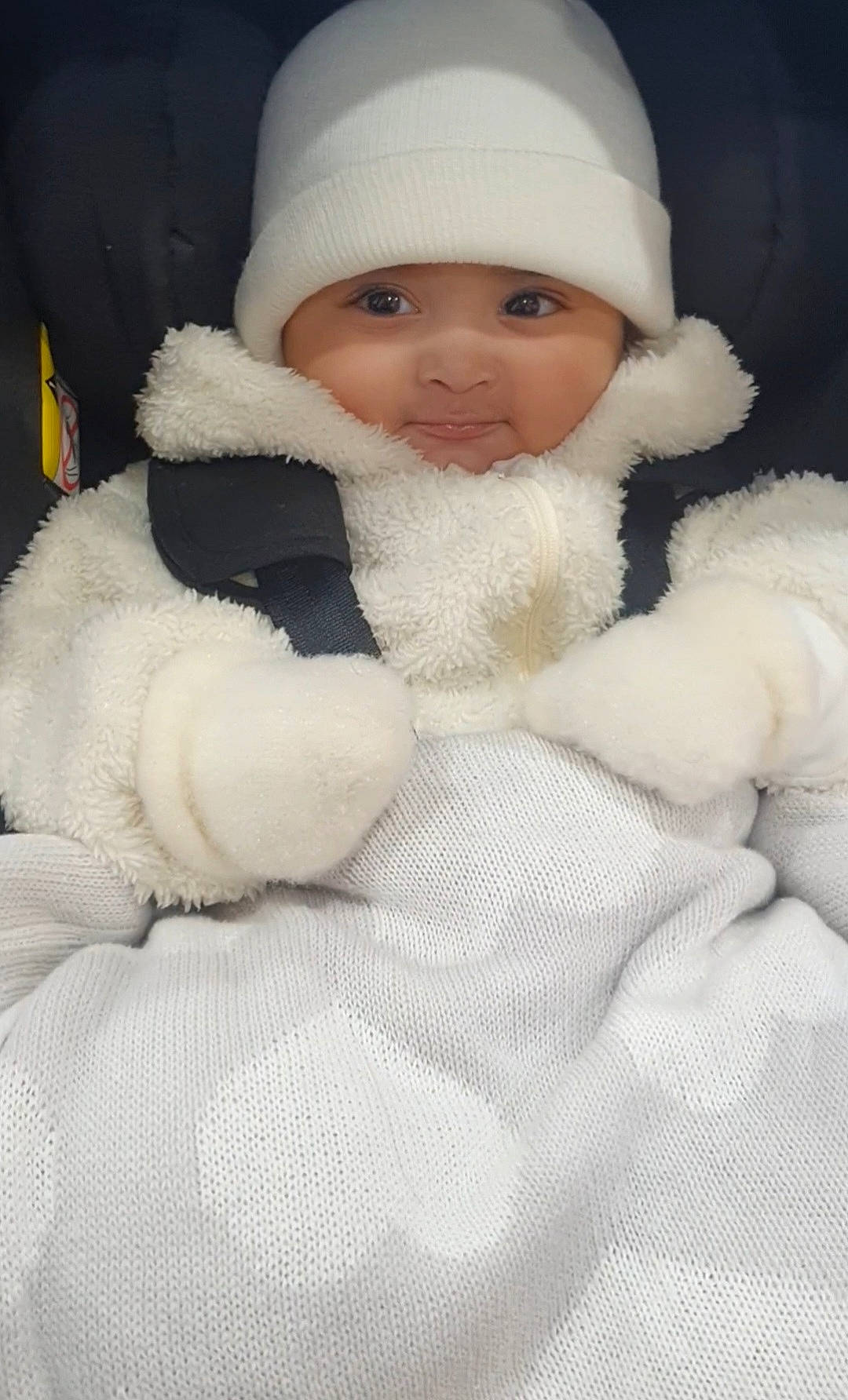 Iden joined the competition — help win amazing prizes! baby, blanket, bundle_up, car_seat, child, cozy, cute, face, indoors, infant, knit_blanket, mittens, portrait, smile, snug, soft_texture, warm, white_hat, winter_clothing, young_child