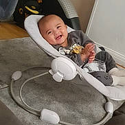 Iden joined the competition — help win amazing prizes! baby, smiling, baby_rocker, clapping, indoor, carpet, happy, child, cute, cozy, clothing, footwear, person, home, furniture, infant, relaxing, seat, toy, expression