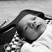 Ford joined the competition — help win amazing prizes! baby, newborn, infant, face, hand, wrench, tool, chrome, blanket, checkered_pattern, black_and_white, portrait, close_up, lying_down, grasp, workshop, metal, floor, gaze, soft_clothing