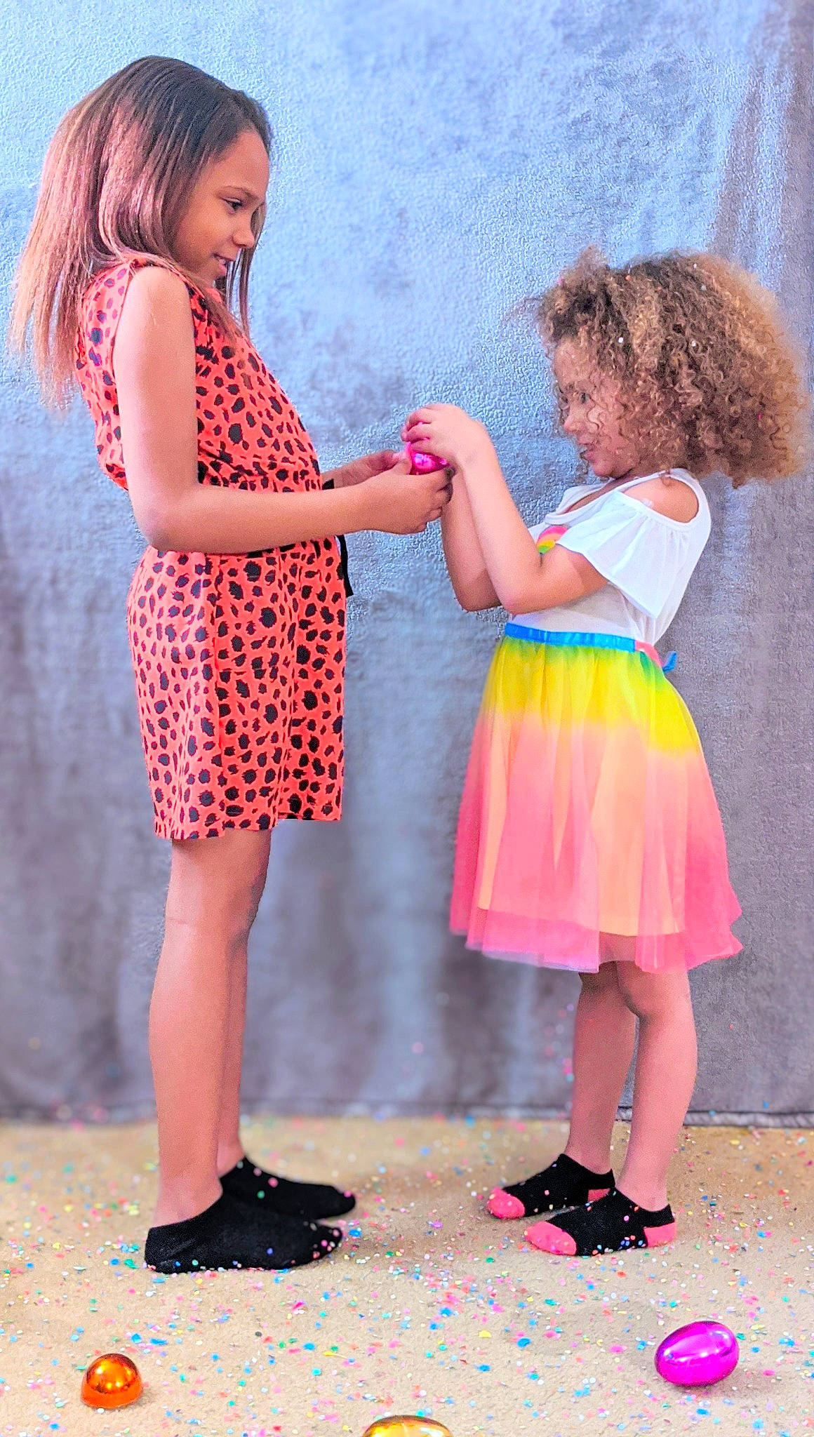 Thalia is registered to the contest to win money with this photo: child, child_model, costume, dress, footwear, fun, gesture, interaction, pattern, person, pink, play, shoe, toddler, vacation