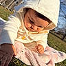 baby, child, hoodie, white_clothing, blanket, grass, outdoor, daylight, curious, exploring, park, nature, soft_texture, cute, portrait, infant, person, sitting, sunlight, warm_clothing