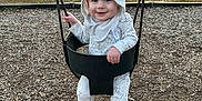 Westyn is registered to the contest to win money with this photo: toddler, child, swing, playground, park, hoodie, smile, happy, outdoor, trees, grass, bench, woodchips, sunset, baby, clothing, feet, person, fun, nature