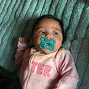 Braylee is registered to the contest to win money with this photo: baby, pacifier, blanket, pink_clothing, infant, cute, face, lying_down, texture, soft, sleepwear, child, newborn, comfort, indoors, person, portrait, expression, rest, young