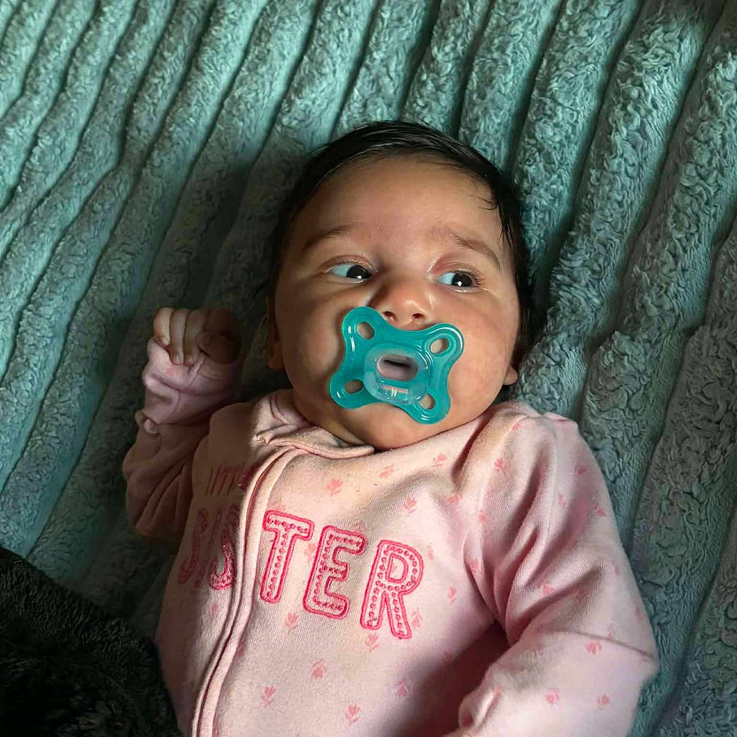 Braylee is registered to the contest to win money with this photo: baby, pacifier, blanket, pink_clothing, infant, cute, face, lying_down, texture, soft, sleepwear, child, newborn, comfort, indoors, person, portrait, expression, rest, young