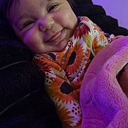 Braylee is registered to the contest to win money with this photo: baby, bed, blanket, child, clothing, comfort, cozy, cute, face, happy, indoor, portrait, purple_light, resting, sleepy, smiling, soft, sunflower_pattern, toddler, warm