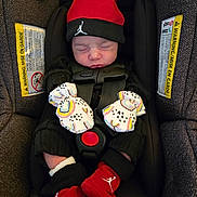 Braylee joined the competition — help win amazing prizes! baby, car_seat, infant, sleeping, mittens, red_hat, red_socks, black_clothing, child, safety_harness, closeup, indoors, cute, newborn, face, headwear, hands, footwear, portrait, resting