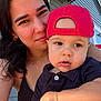 Christopher joined the competition — help win amazing prizes! baby, child, woman, person, face, smile, hat, red_cap, black_shirt, arm, bracelet, outdoor, house, window, daylight, closeup, portrait, skin, happy, casual