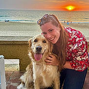 Una participe au concours pour gagner de l'argent avec cette photo : woman, dog, golden_retriever, sunset, beach, ocean, smiling, hugging, outdoor, casual_clothing, long_hair, sunglasses, happy, pet, sand, water, sky, waves, nature, evening
