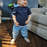 Liam joined the competition — help win amazing prizes! toddler, child, standing, smiling, indoor, living_room, couch, lamp, wooden_floor, jeans, shirt, shoes, sunlight, shadow, furniture, home, happy, person, casual_clothing, modern