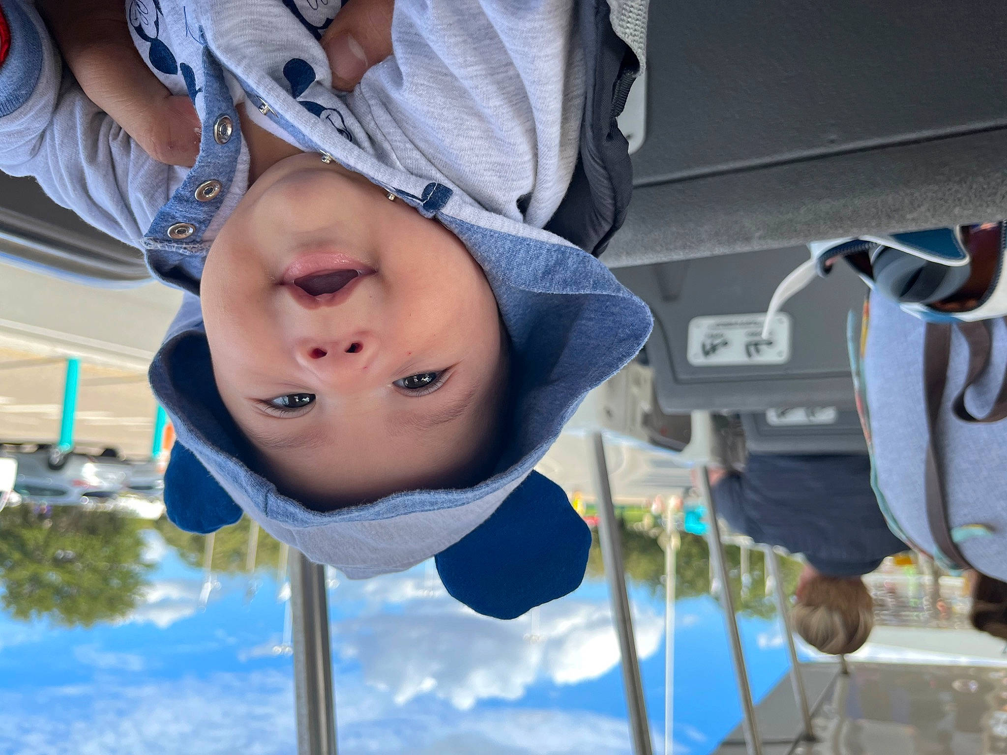 Jose is registered to the contest to win money with this photo: baby, baby_products, child, city, cloud, electric_blue, fun, happy, hat, headwear, leisure, outdoor_play_equipment, person, plant, recreation, sky, toddler, tree, vacation, vehicle_door