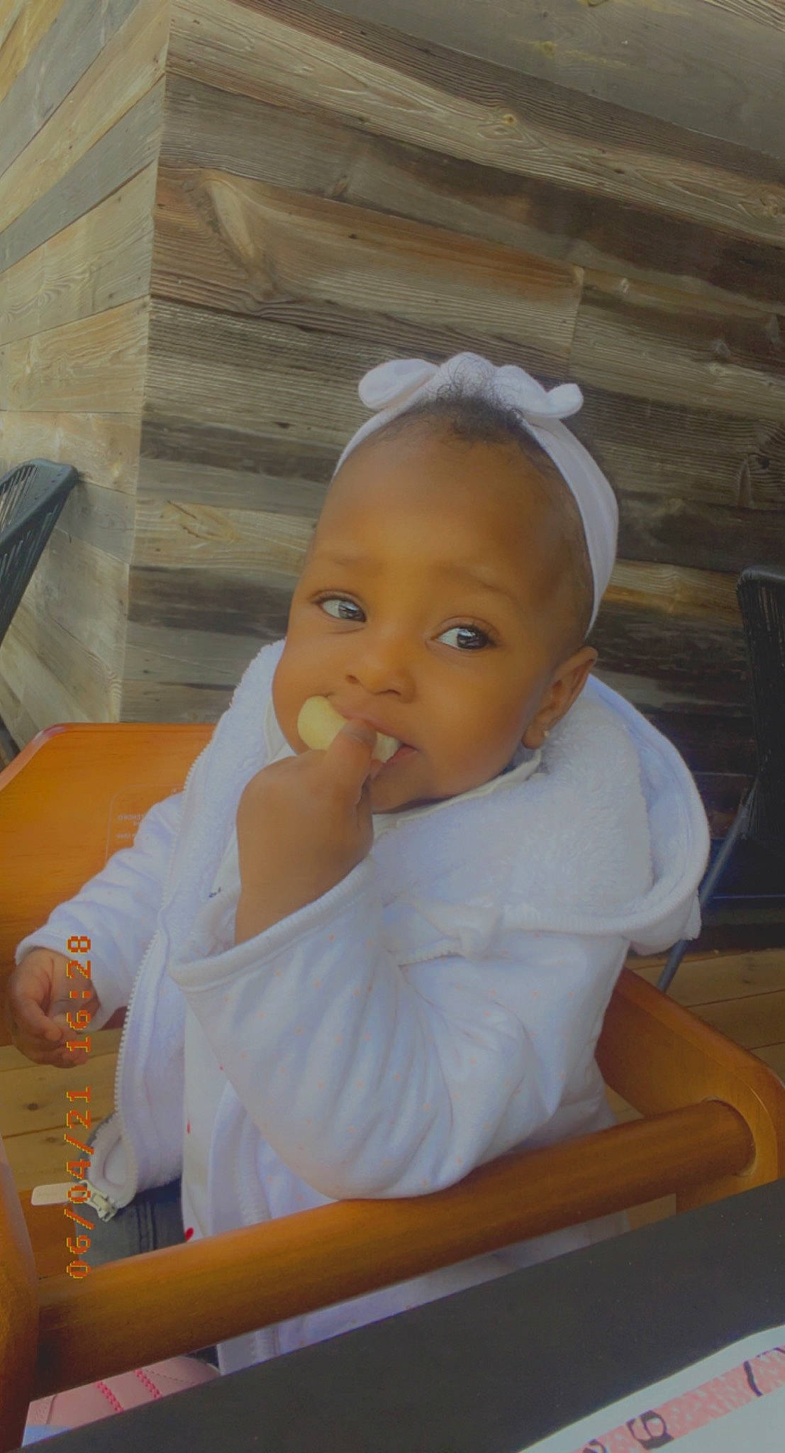 Maylah participe au concours pour gagner de l'argent avec cette photo : baby, baby_products, baby_toddler_clothing, blurred, chair, cheek, child, comfort, ear, happy, headband, person, room, sitting, thumb, toddler, wood