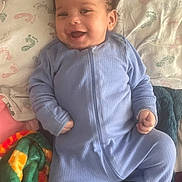 Zion joined the competition — help win amazing prizes! baby, smiling, blue_onesie, blanket, quilt, infant, cute, happy, child, face, lying_down, cozy, soft_fabric, home, portrait, young_child, comfort, indoor, person, sleepwear