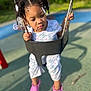Ava is registered to the contest to win money with this photo: toddler, child, swing, playground, outdoor, hair_accessories, pink_shoes, floral_outfit, daylight, greenery, metal_chains, rubber_swing, shadow, concrete_floor, expression, holding, cute, young_child, summer, fun