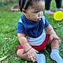 baby, child, toddler, sitting, grass, outdoor, bib, white_socks, braids, profile, side_view, chubby_cheeks, cute, red_shorts, blue_shirt, yellow_toy, lawn, background_legs, portrait, small_hands