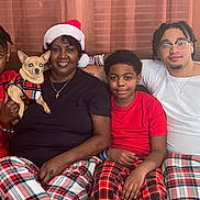 Trixie Day joined the competition — help win amazing prizes! adults, chihuahua, children, christmas, couch, curtains, dog, family, festive, group_photo, holiday, indoor, living_room, pajamas, pet, plaid, portrait, santa_hat, sitting, smiling