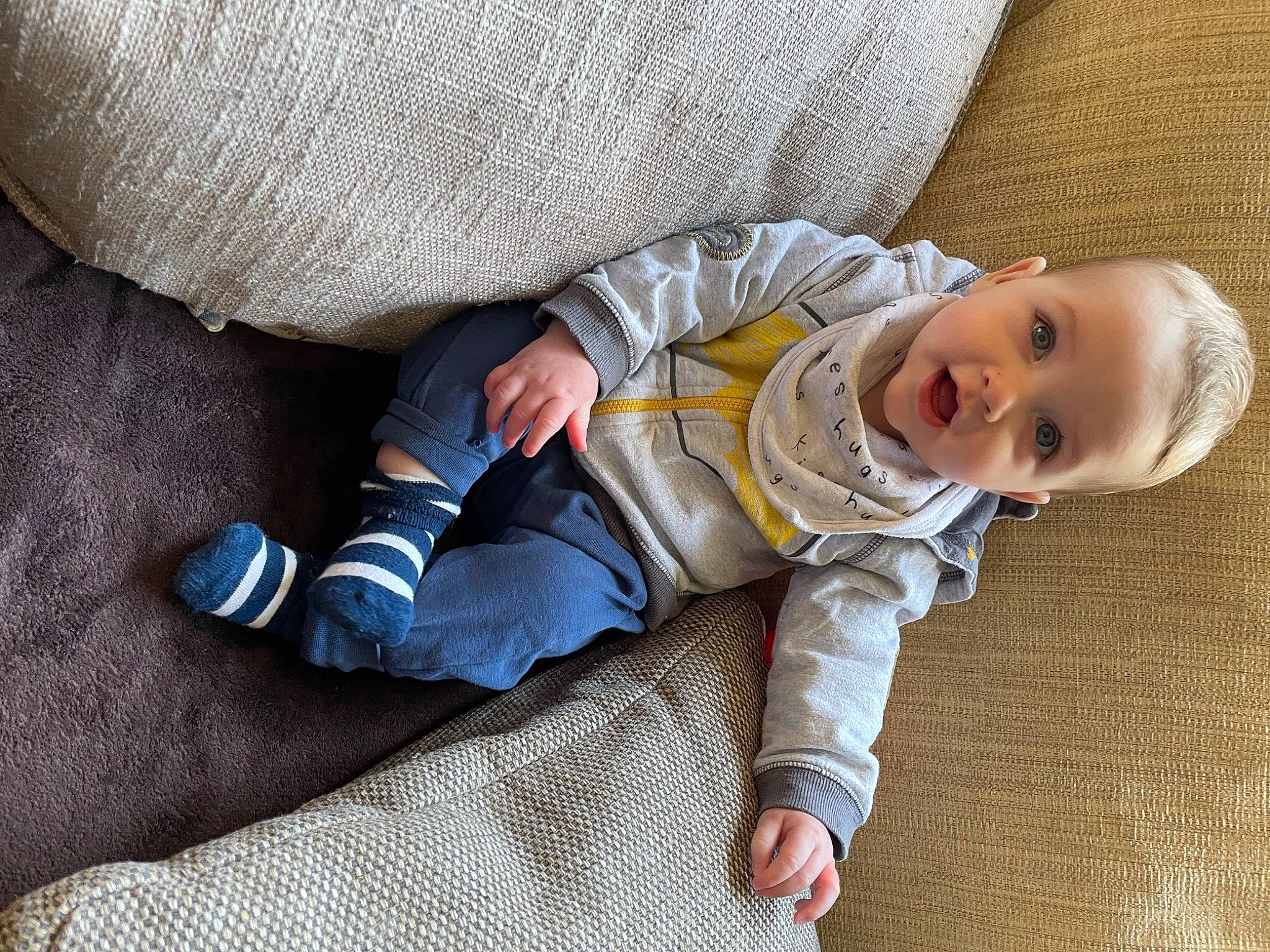Alfred joined the competition — help win amazing prizes! arm, baby, baby_toddler_clothing, child, comfort, eye, flooring, foot, hand, human_body, leg, linens, nap, person, sitting, skin, sleeve, smile, sock, toddler